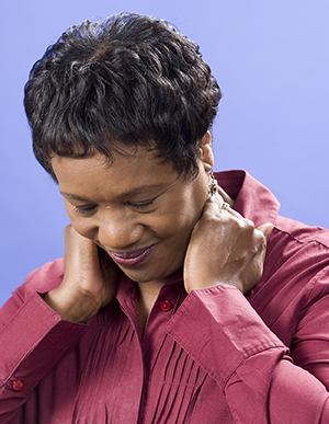 Woman massaging back of neck.