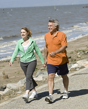 Woman and man walking at beach.