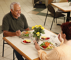 Man and woman eating healthy food in restaurant.