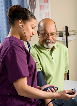 Health care provider taking person's blood pressure.